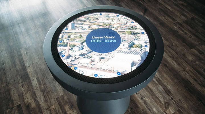 Round touch table with an interactive map of company history